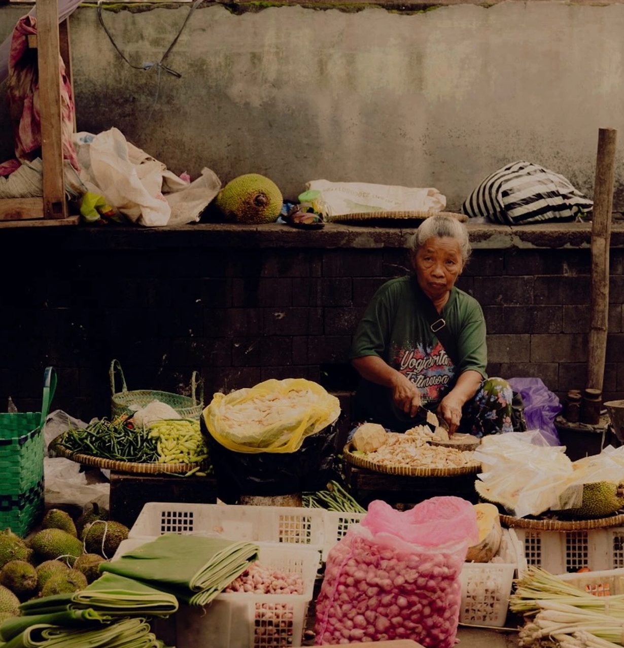 A market trader preparing produce at her stall in Southern Thailand